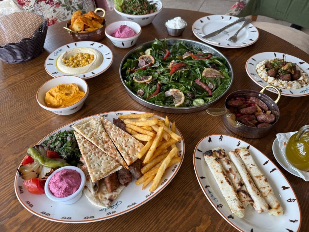 A delicious spread of Mediterranean dishes including salads, hummus, and grilled meats beautifully presented.